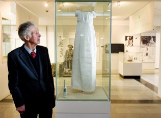 Tom Costello from Ennis, Co. Clare (who is a relative of Ó Conaire) with the christening gown. | Photo: Andrew Downes