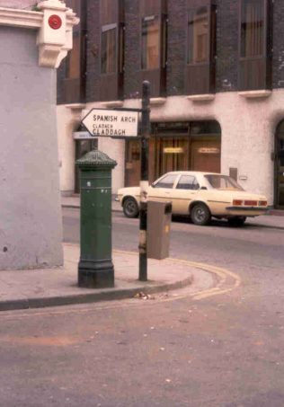 Photograph, by Derek Biddulph, of the Penfold Pillar Box on the corner of High St and Mainguard St, Galway, c. 1980s. | Galway City Museum Collection.